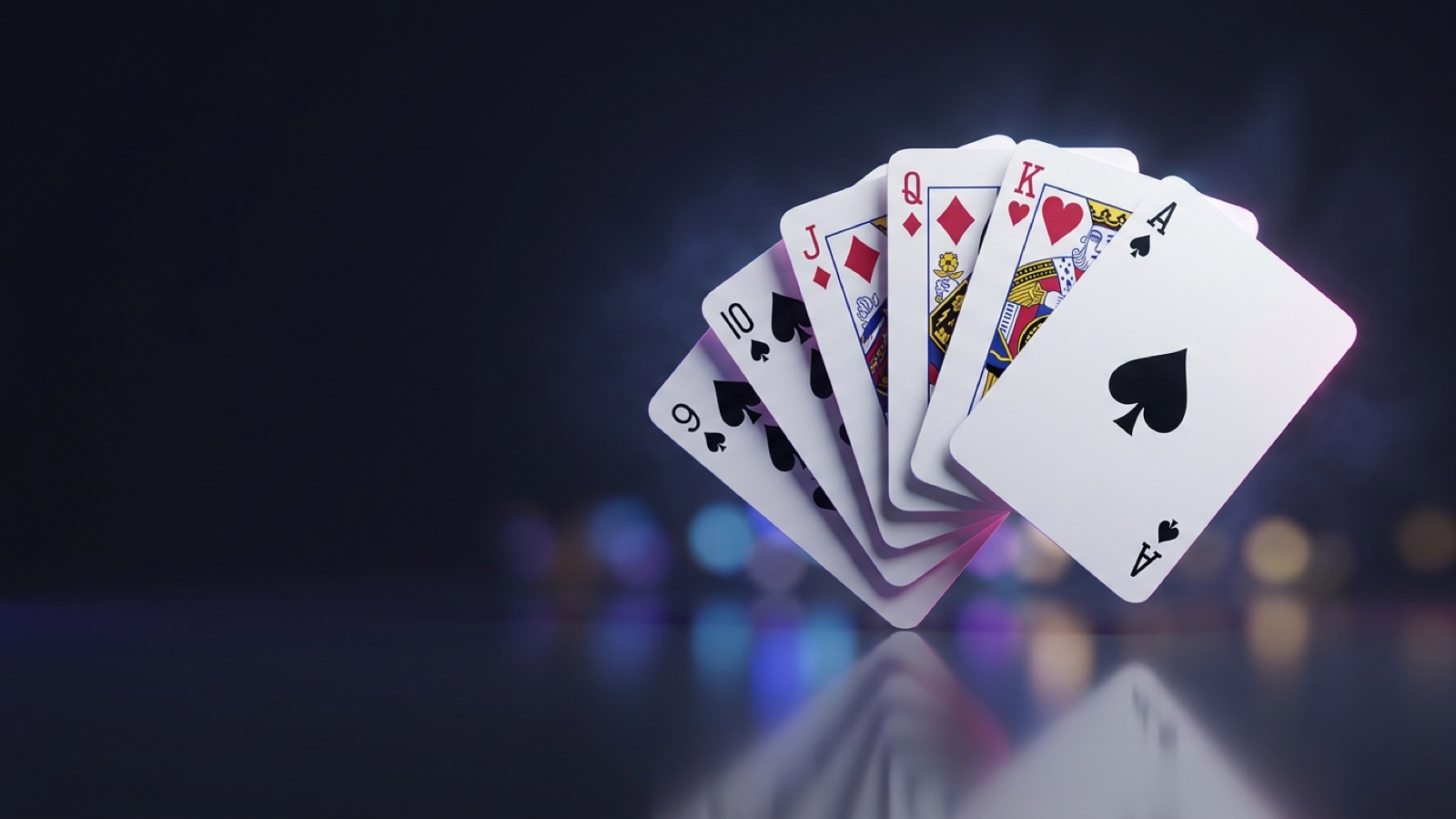 Playing cards including a five of clubs and a jack of hearts fanned on dark felt.